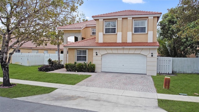 mediterranean / spanish-style home with a garage and a front lawn