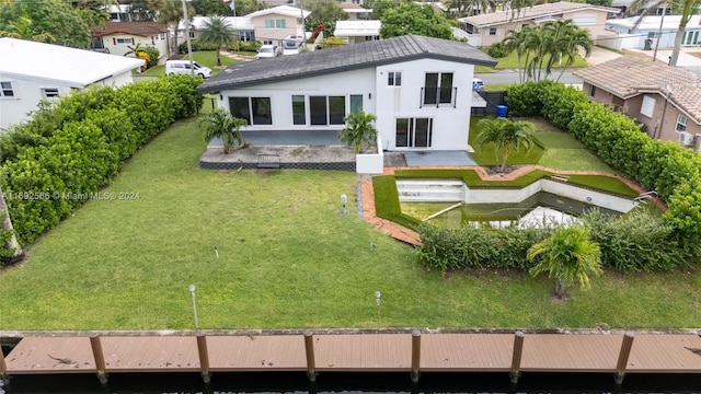 2537 Marathon Ln, Fort Lauderdale, FL 33312 - rear view of house featuring a residential view, stucco siding, a patio, a yard, and a balcony