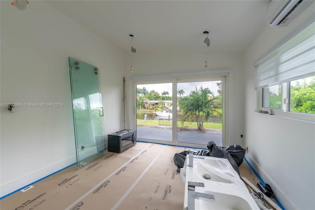 interior space featuring access to exterior and an AC wall unit