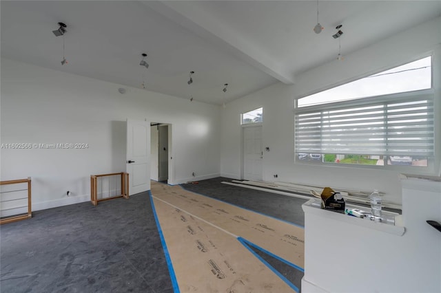 empty room featuring beamed ceiling