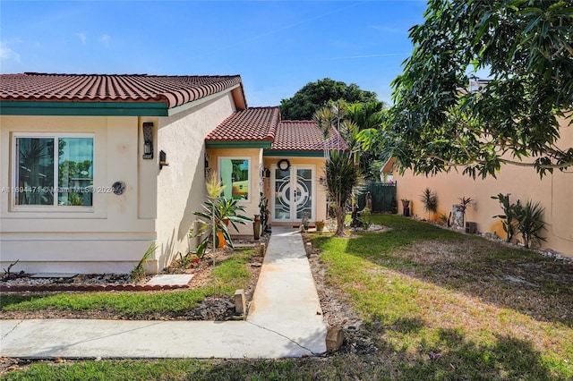 mediterranean / spanish home featuring a front yard