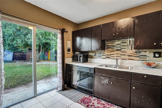 kitchen with dishwasher, sink, decorative backsplash, dark brown cabinets, and light tile patterned floors