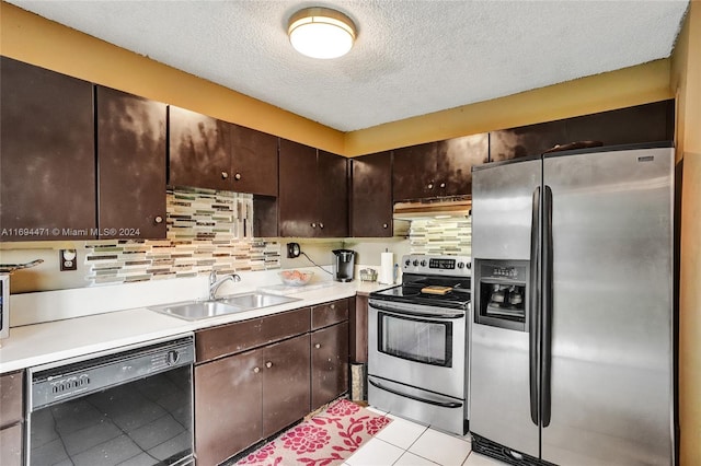 kitchen featuring sink, tasteful backsplash, a textured ceiling, dark brown cabinets, and appliances with stainless steel finishes