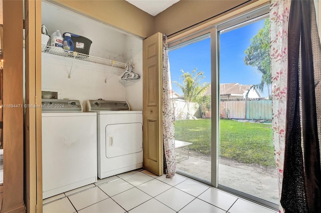 clothes washing area featuring light tile patterned floors and independent washer and dryer