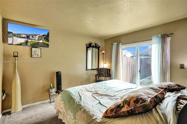 carpeted bedroom featuring a textured ceiling