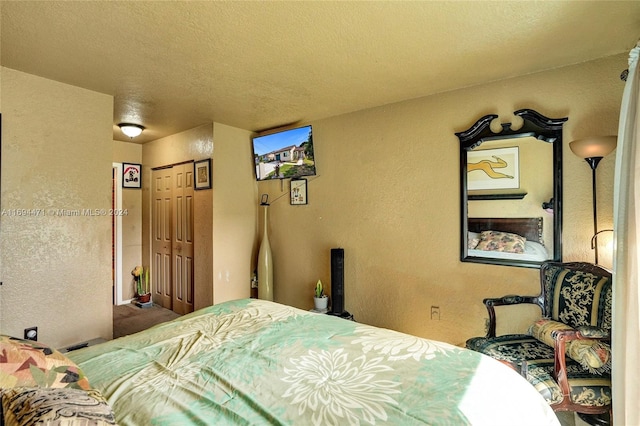 bedroom featuring a textured ceiling and a closet