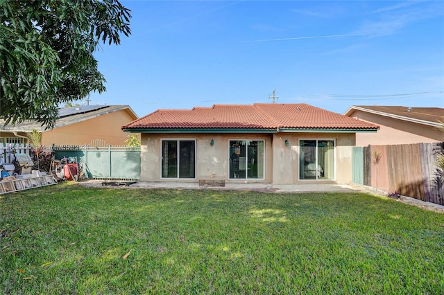 rear view of property featuring a yard