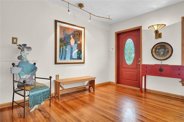 entrance foyer featuring wood-type flooring and a textured ceiling