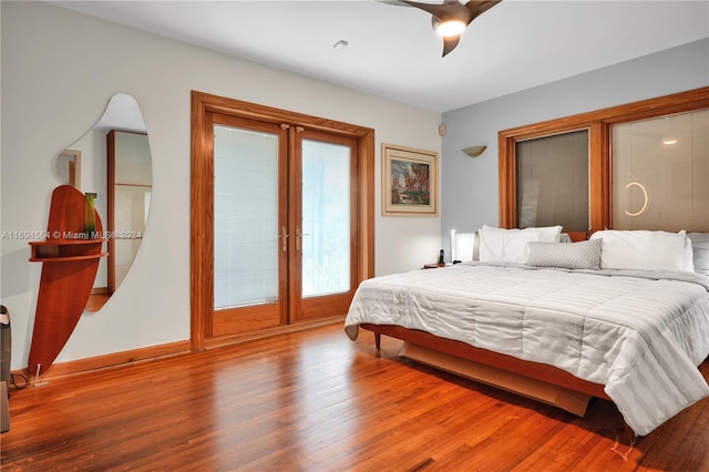 bedroom with hardwood / wood-style floors, ceiling fan, and french doors