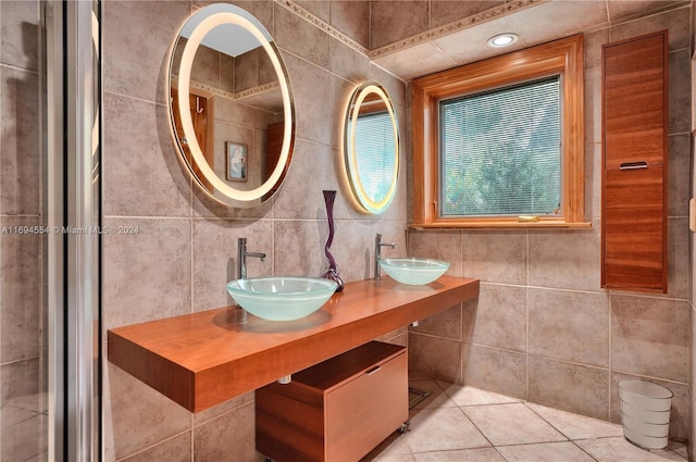 bathroom featuring tile patterned flooring, vanity, and tile walls