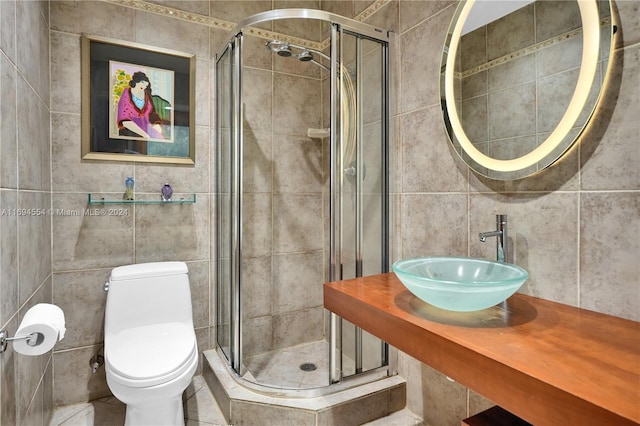 bathroom featuring an enclosed shower, toilet, tile walls, and sink