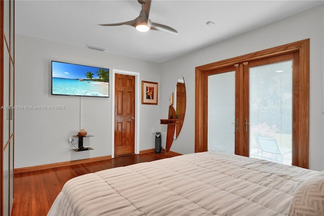 bedroom featuring hardwood / wood-style flooring, ceiling fan, and access to outside