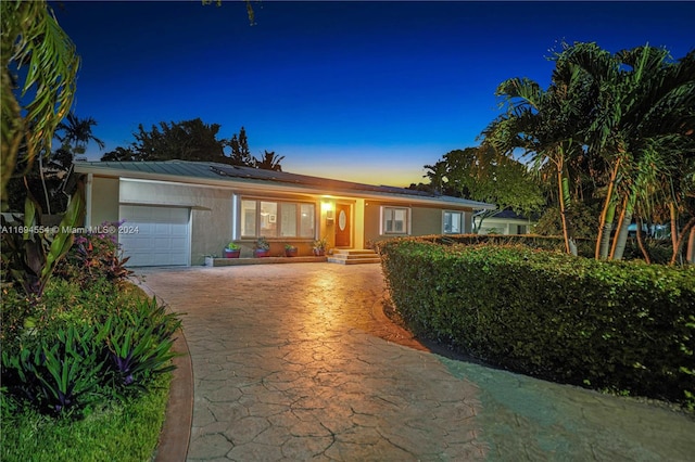 ranch-style home featuring a garage