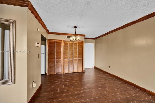 kitchen featuring white appliances, hardwood / wood-style flooring, track lighting, and stacked washer and clothes dryer