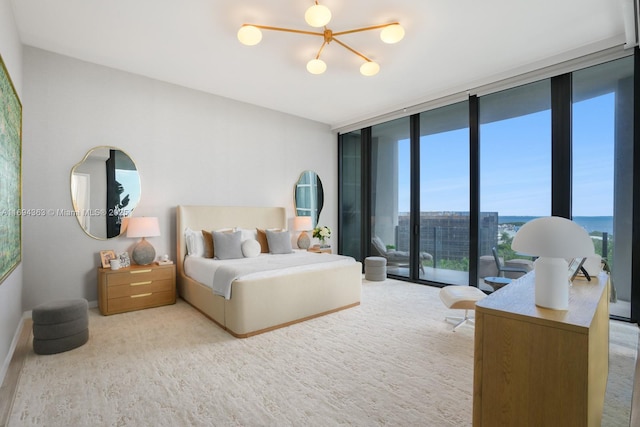 bedroom with a chandelier, access to outside, and floor to ceiling windows