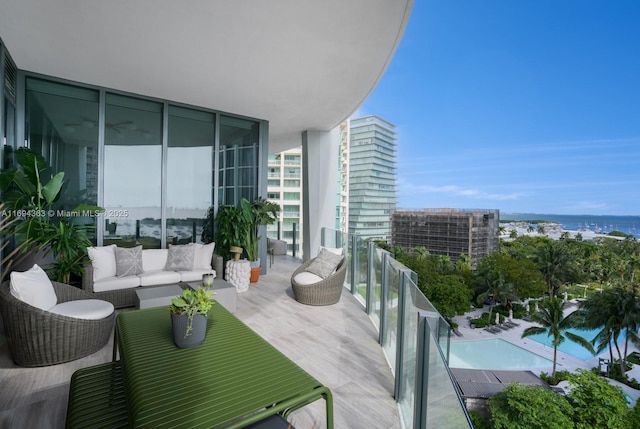 balcony with outdoor lounge area and a water view