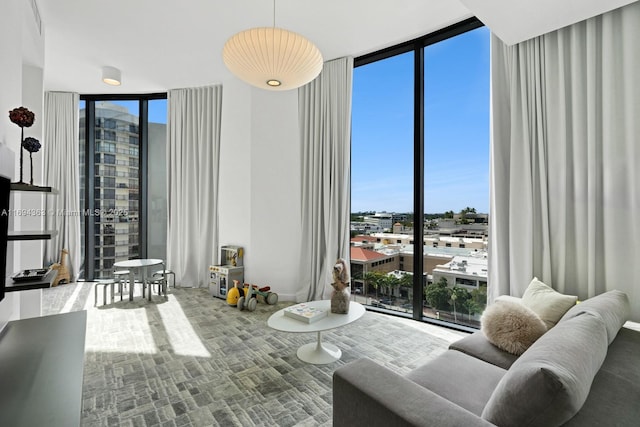 living room featuring floor to ceiling windows, carpet, and a healthy amount of sunlight