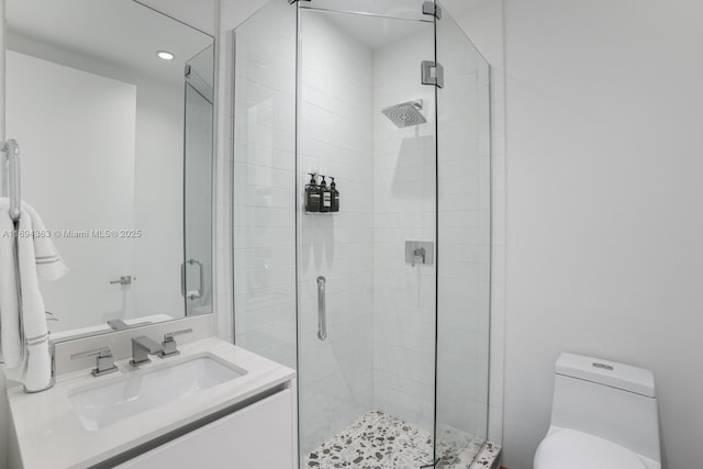 bathroom with vanity, toilet, and walk in shower