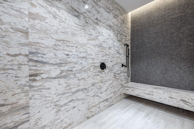 bathroom featuring hardwood / wood-style flooring and walk in shower