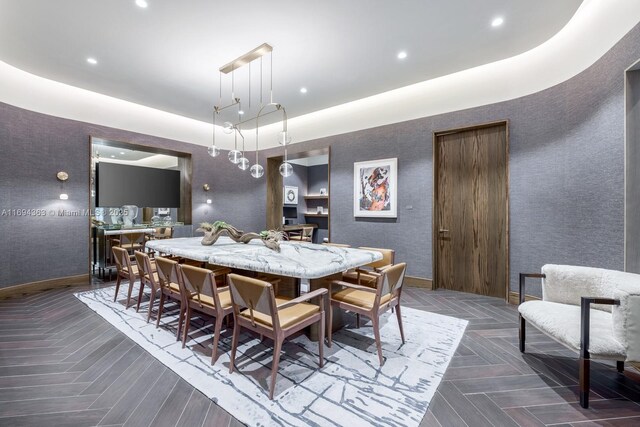 dining room with a tray ceiling and dark parquet flooring