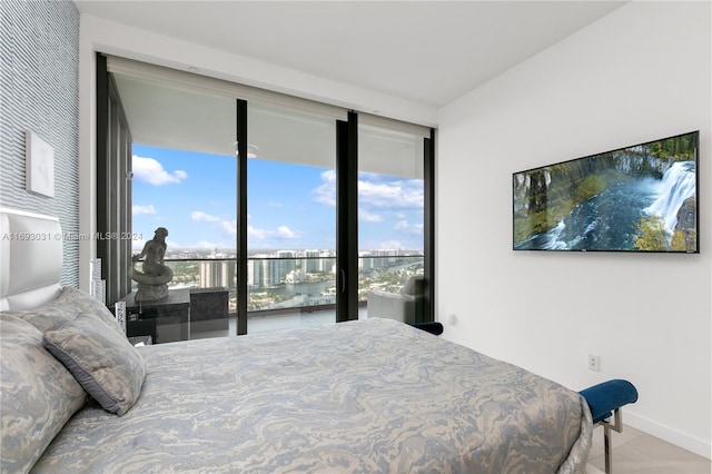 bedroom featuring light tile patterned floors and access to outside