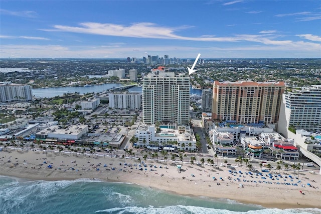 birds eye view of property featuring a water view and a beach view