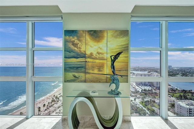 bathroom with a view of the beach and a water view