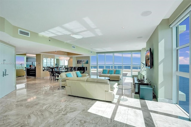 living room featuring expansive windows and a healthy amount of sunlight