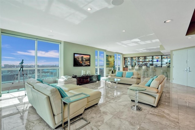 living room featuring expansive windows and a healthy amount of sunlight