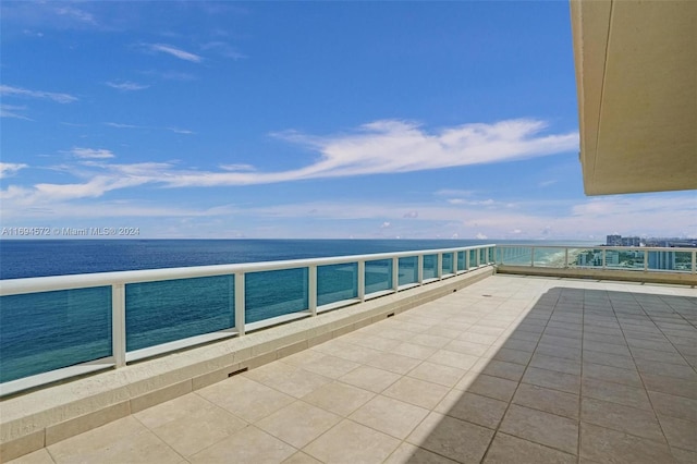 view of patio featuring a water view and a balcony