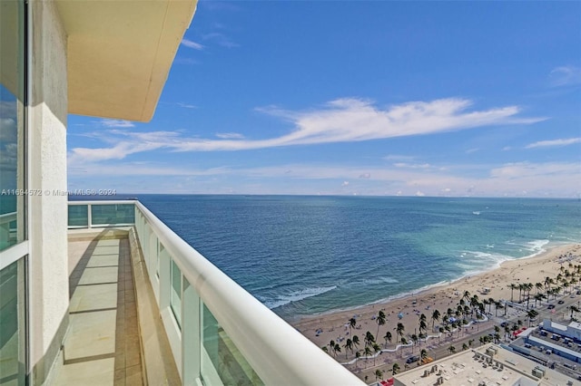 balcony featuring a water view and a view of the beach