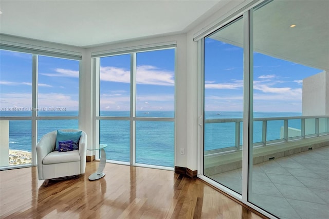 unfurnished sunroom with a water view