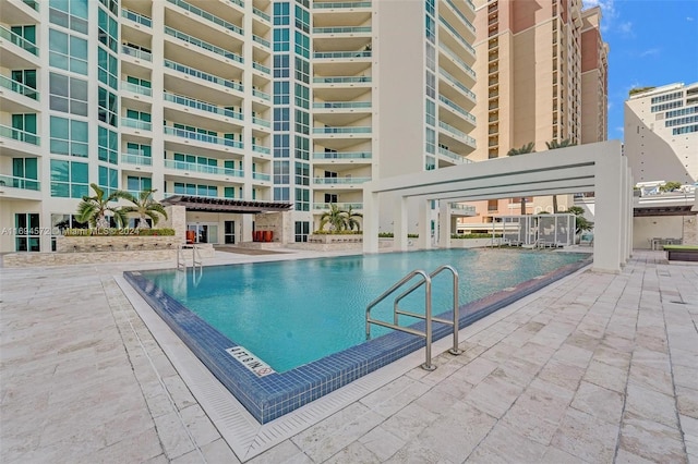 view of pool featuring a pergola and a patio