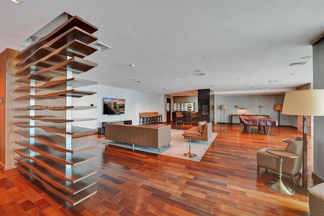 living room with hardwood / wood-style floors and pool table