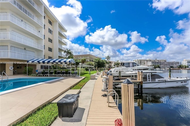 view of pool with a boat dock and a water view