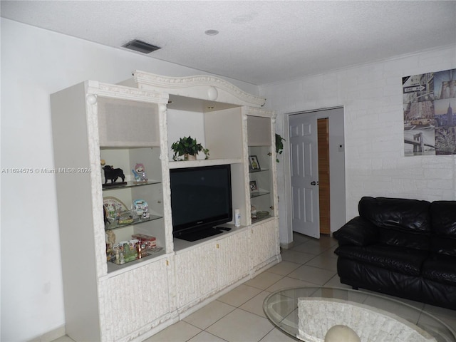 living room featuring light tile patterned floors and a textured ceiling