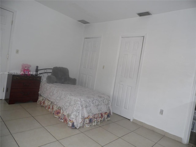 bedroom featuring light tile patterned flooring