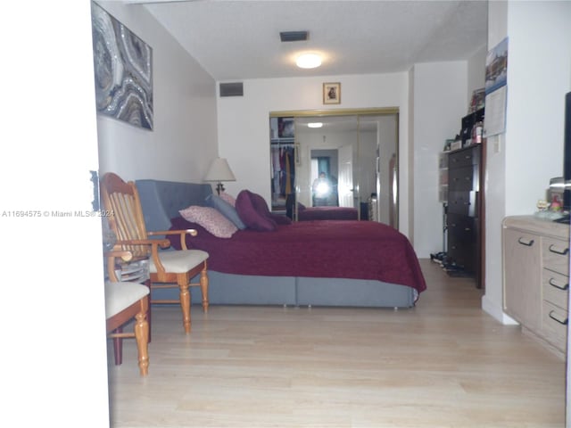 bedroom featuring light hardwood / wood-style floors and a closet