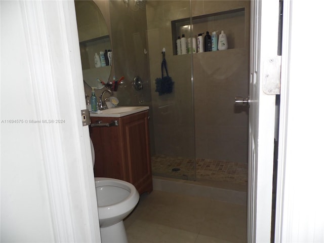 bathroom featuring vanity, tile patterned floors, and a shower with door