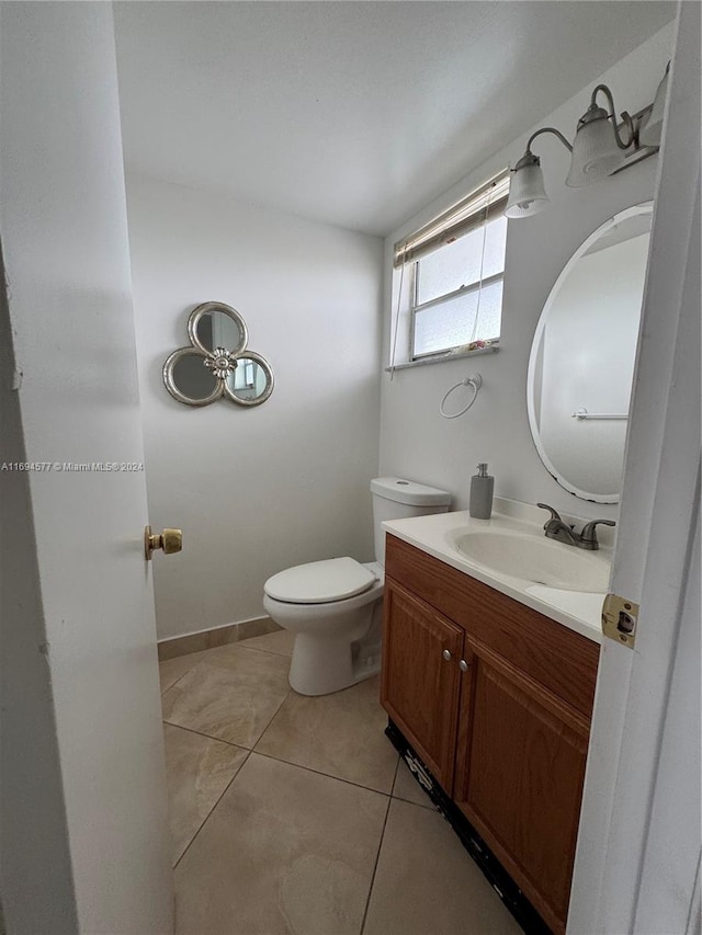 bathroom featuring tile patterned flooring, vanity, and toilet