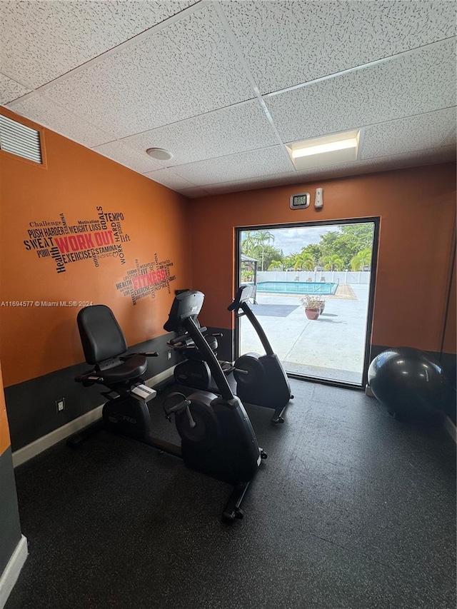 workout room with a drop ceiling