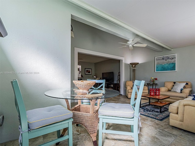 dining space with beam ceiling and ceiling fan