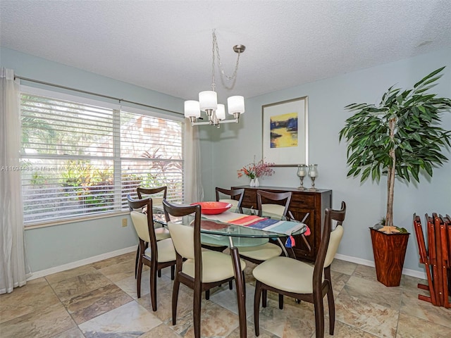 dining room with a chandelier and a textured ceiling