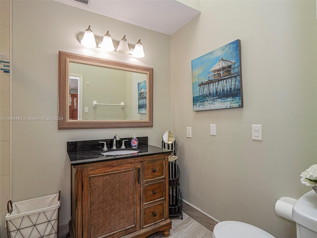 bathroom featuring vanity and toilet