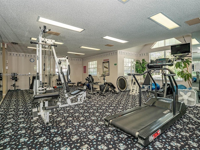 gym with carpet and a textured ceiling