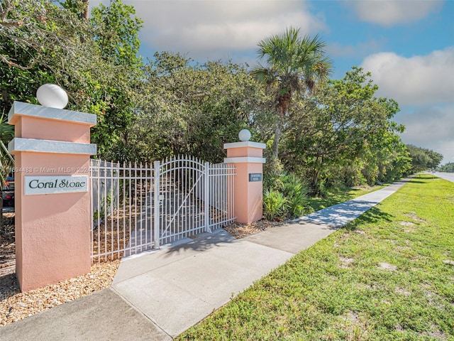 view of gate with a yard