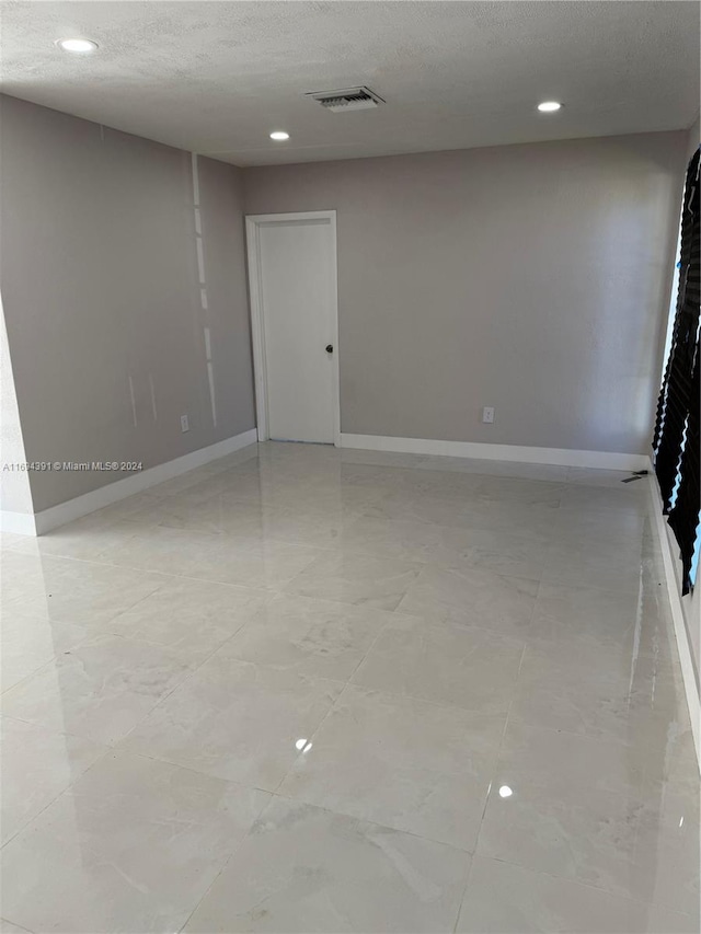 empty room with a textured ceiling