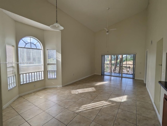 spare room with ceiling fan, light tile patterned flooring, and high vaulted ceiling