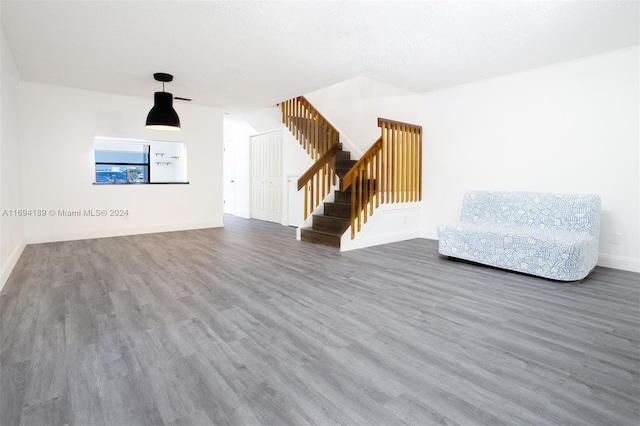 interior space with a textured ceiling and dark hardwood / wood-style floors