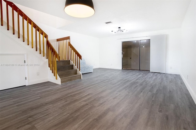 unfurnished living room featuring dark wood-type flooring